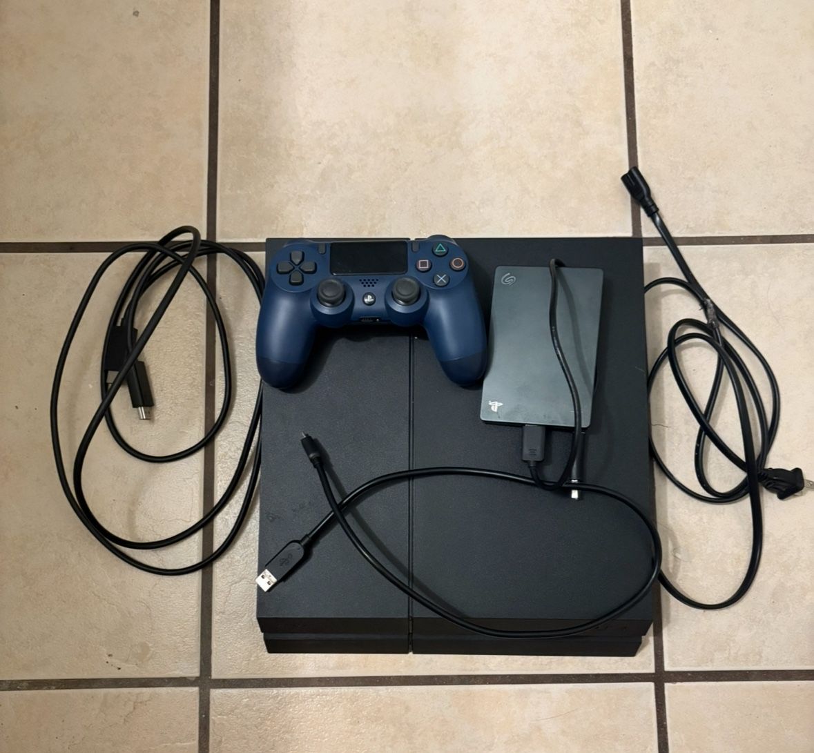 PS4 with Control, Charger, 2TB Hard Drive Extension, HDMI Cable And Games Included.