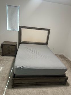 Queen bed with upholstered headboard and table