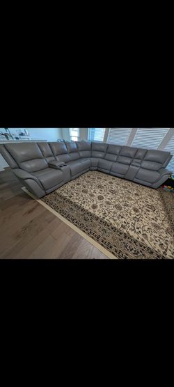 Spacious 7- Seat Sectional Sofa including 4 power recliners  plus 2 consoles