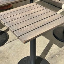 Bistro BarPub height Square Wood Top Patio Table. Sturdy square table. Has wood slatted top and black metal pedestal base. Great for outdoor use on a 