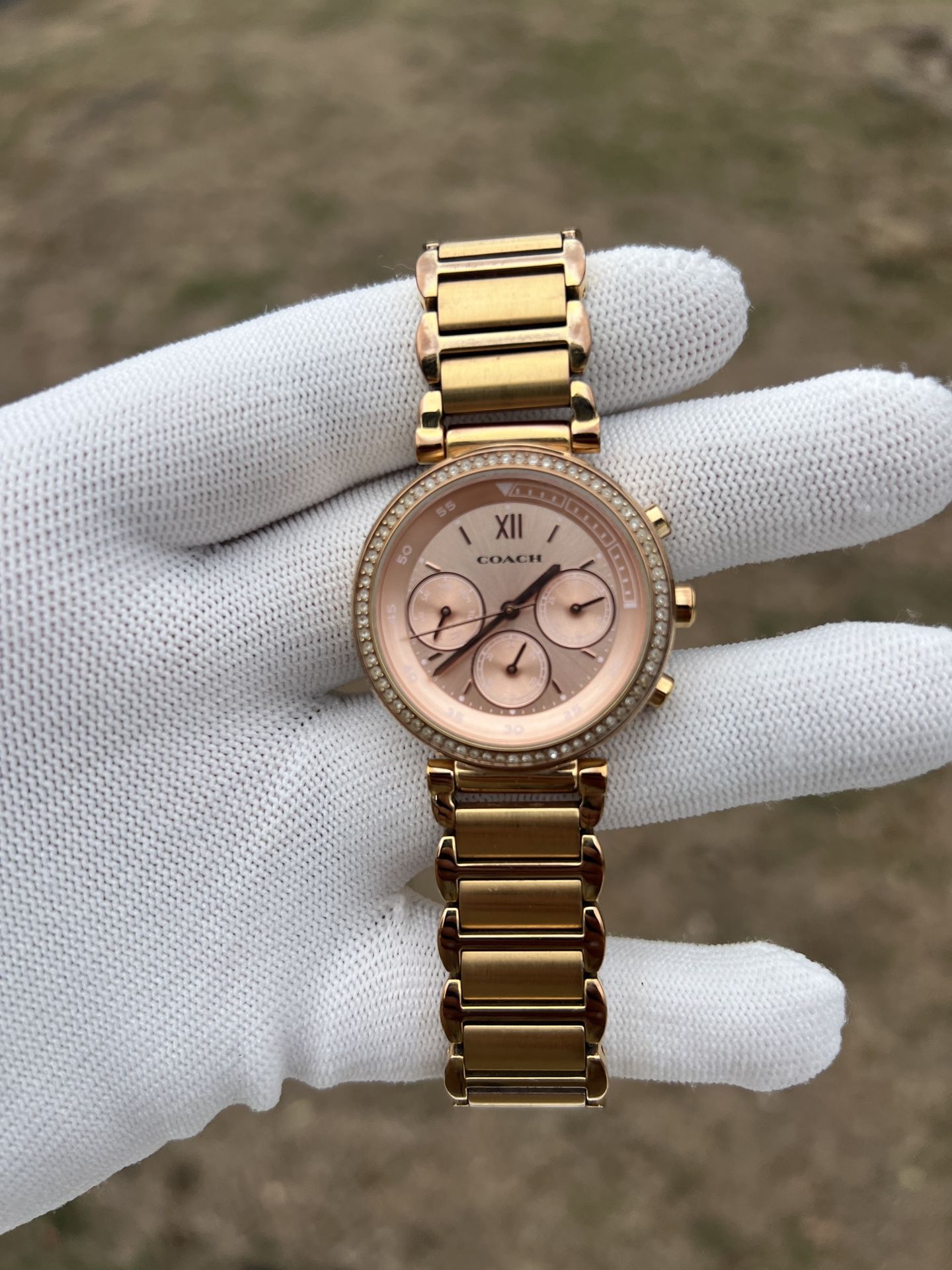 Coach women’s rose gold watch with diamond bezel