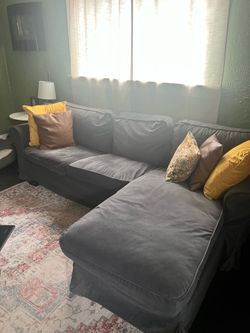 Grey L shaped sectional couch.