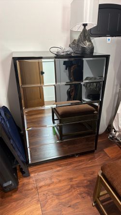 Glossy black and mirrored dresser.