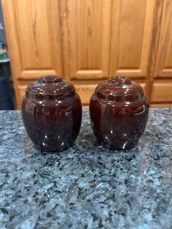 Vintage Glossy Brown Red Clay Salt and Pepper Shakers.  Size approximately 3 inches tall.  Preowned good condition.  Has been on display in a cabinet 
