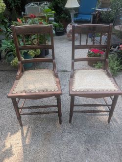 Two vintage carved solid wood chairs