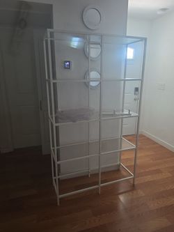 White Metal and Glass Etagere Bookshelf  sofa and chair