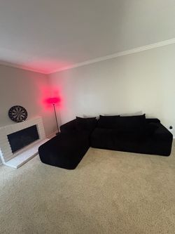Black Boneless couch and Tv Set
