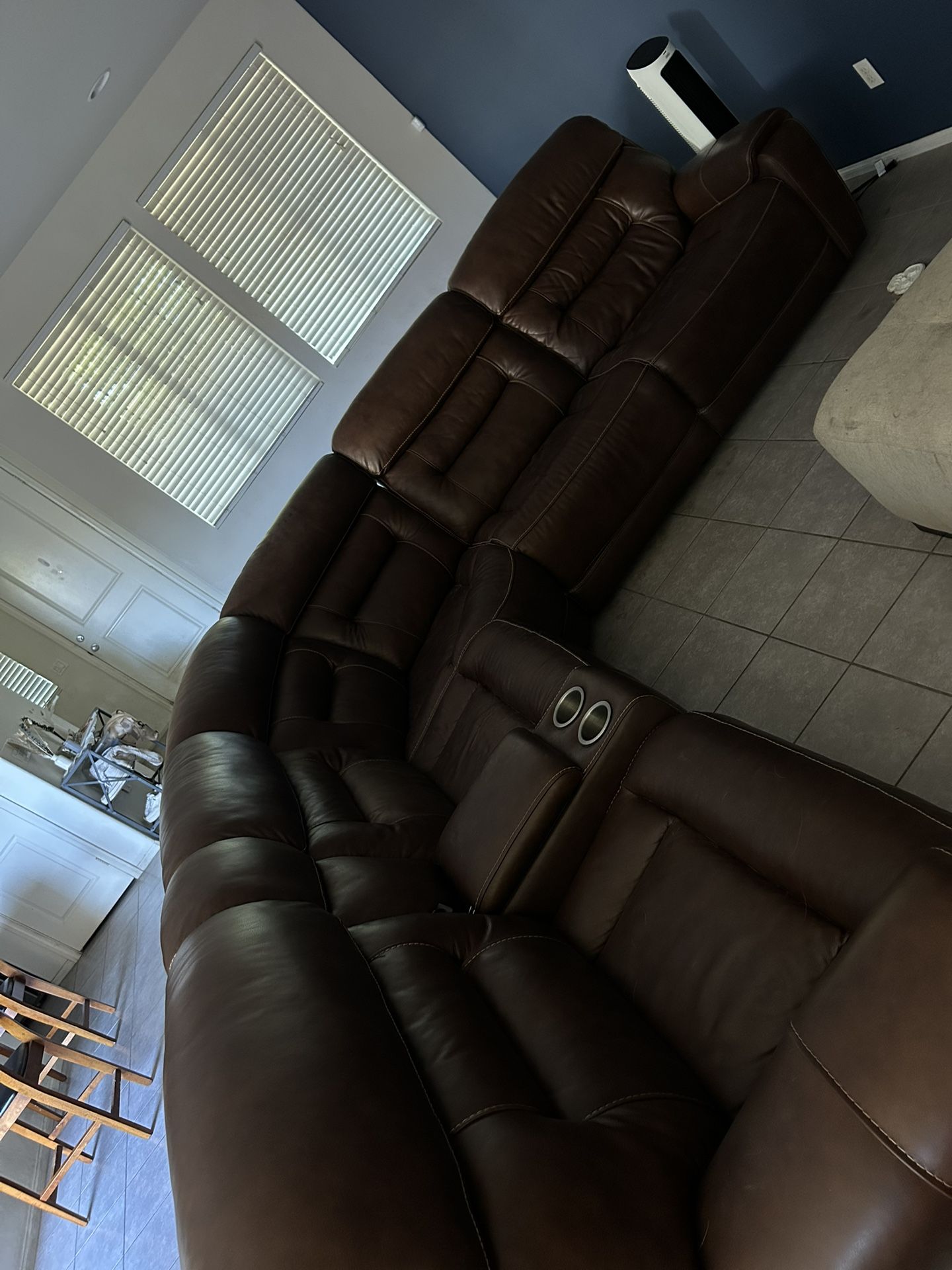 Large brown leather sectional couch