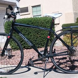 His and Her REI Novara Buzz and Big Buzz bikes w/ 700c bicycle tires