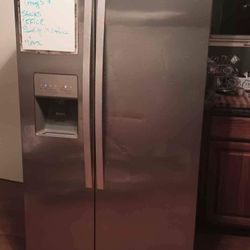 Stainless Steel Whirlpool Fridge./ Black Stove