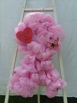 Pink deco mesh support ribbon wreath.