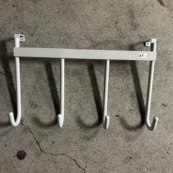 white metal over-the-door or under-shelf hanging rack with four hooks