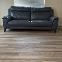 Blue 87 Inch Reclining Leather Sofa In Great Conditions.