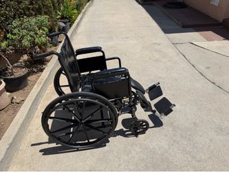 18 inches wide wheelchair in excellent condition with legs extended by drive