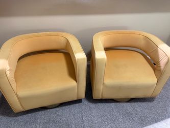 Two Yellow accent chairs that swivel
