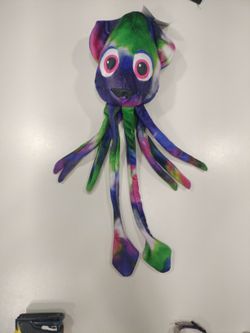 This is a Tuffy Ocean Creatures Squid dog toy in the Green/Kaleidoscope color.   ( Red / Black Bin )