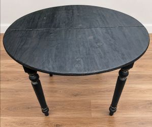 Round top table with a charcoal whitewashed base