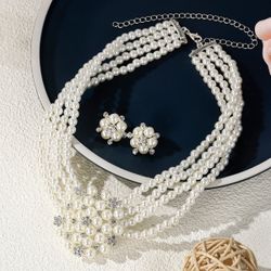 Jewelry set with luxurious and sophisticated style. Wedding dress, formal gown, accessories. Multi-layered pearl necklace and earrings. Two-piece set.