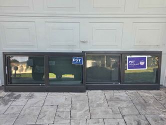 Two Brand New 47.5W x 23.5H PGT Impact Sliding Windows.