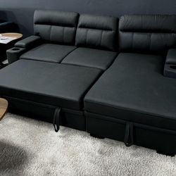 Black leather pull out sofa with upholders and storage