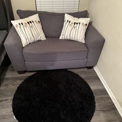 Gray Love Seat and Black Area Rug