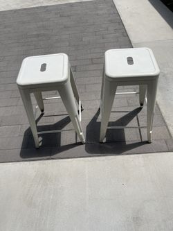 Two metal counter height bar stools