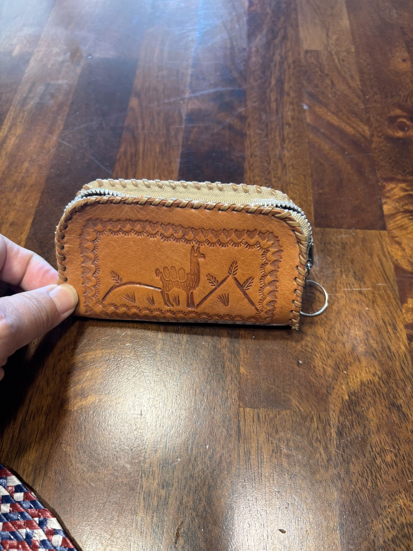 Peru leather coin purse with a stitched design featuring a llama and mountains