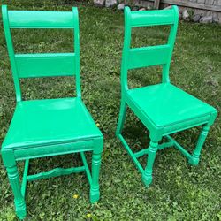 two green antique statement chairs 