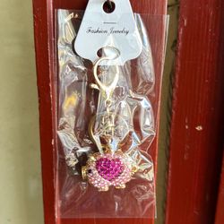 pink pig keychain with a red heart