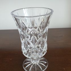 A vintage cut glass vase or hurricane candle holder with a pedestal base.