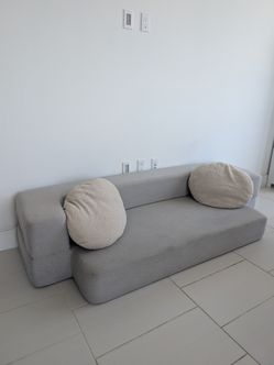 Low seating, foldable sofa