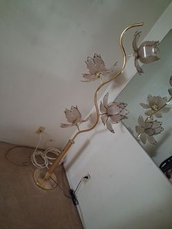 Brass lamp with four glass flower heads on it