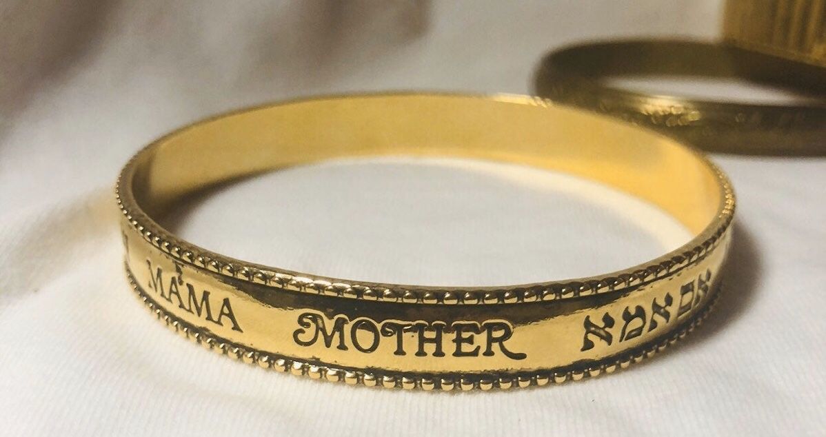 AM Vintage Avon 1993 Gold Tone Bracelet which reads “mother” in several languages. Excellent condition.