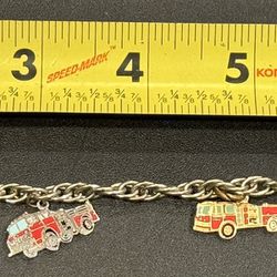 Fireman/Pierce Firetruck charm bracelet. Approximately 7” length. 4 charms total.