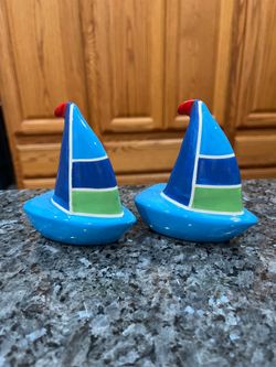 Vintage  Ceramic Sail Boats Pair of Salt and Pepper Shakers.  Size approximately 4 inches tall.  Preowned the bottoms have a little wear due to sittin