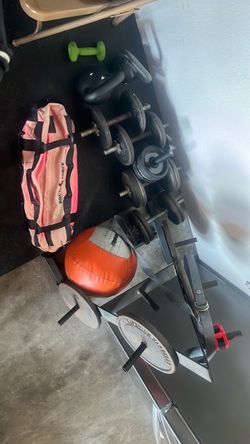 Random weights, sandbag, and plate stand with plates