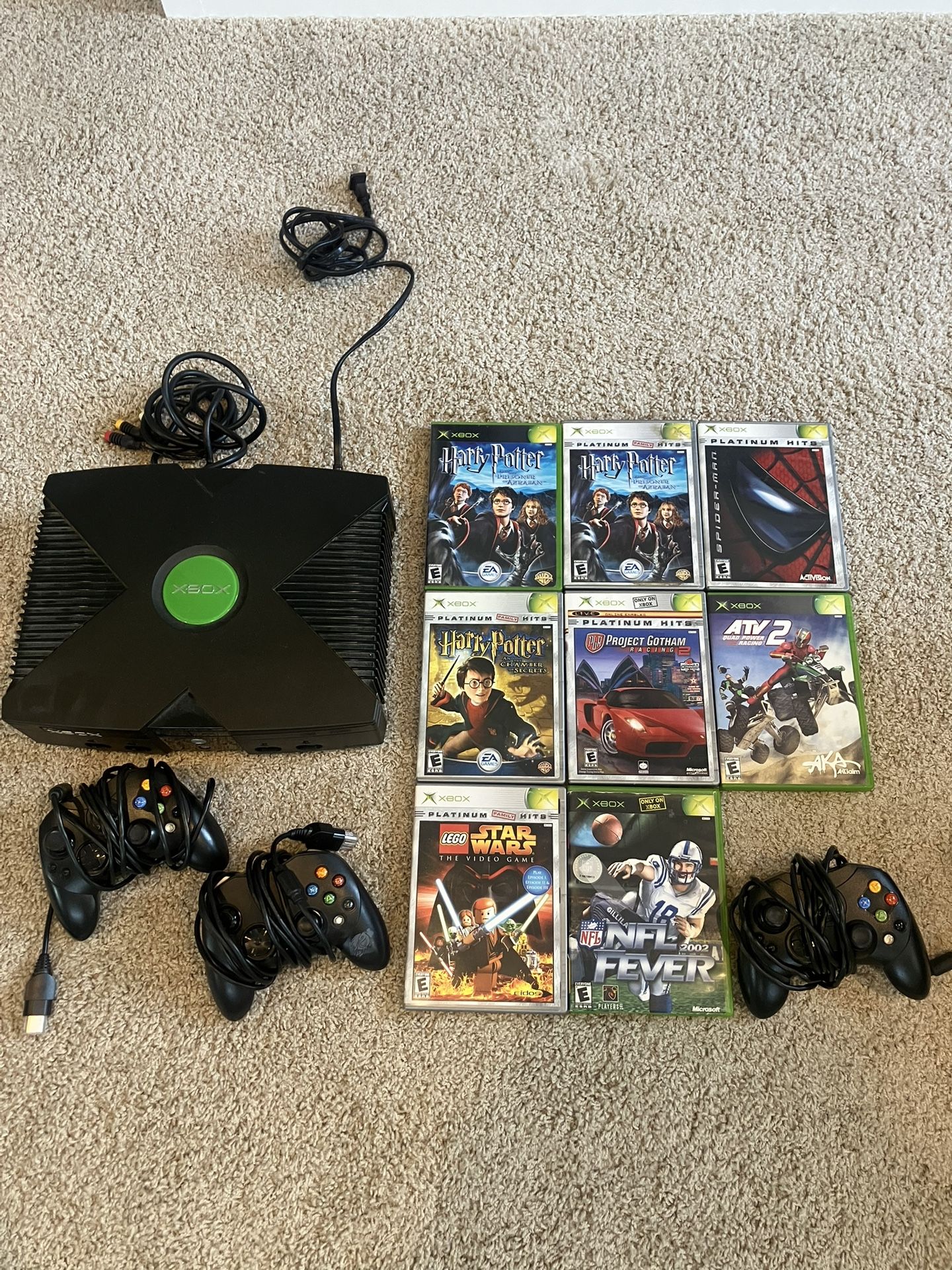 xbox with games controllers and cables