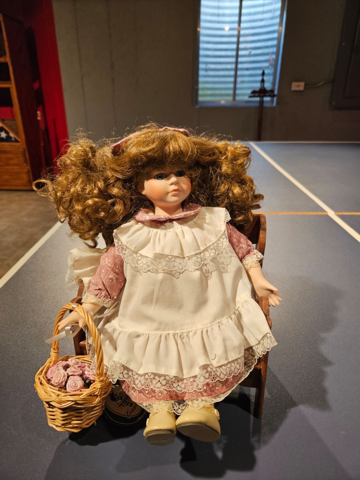 Porcelain Doll On Bench , With Basket Of Roses