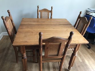 Brown wooden table with four chairs