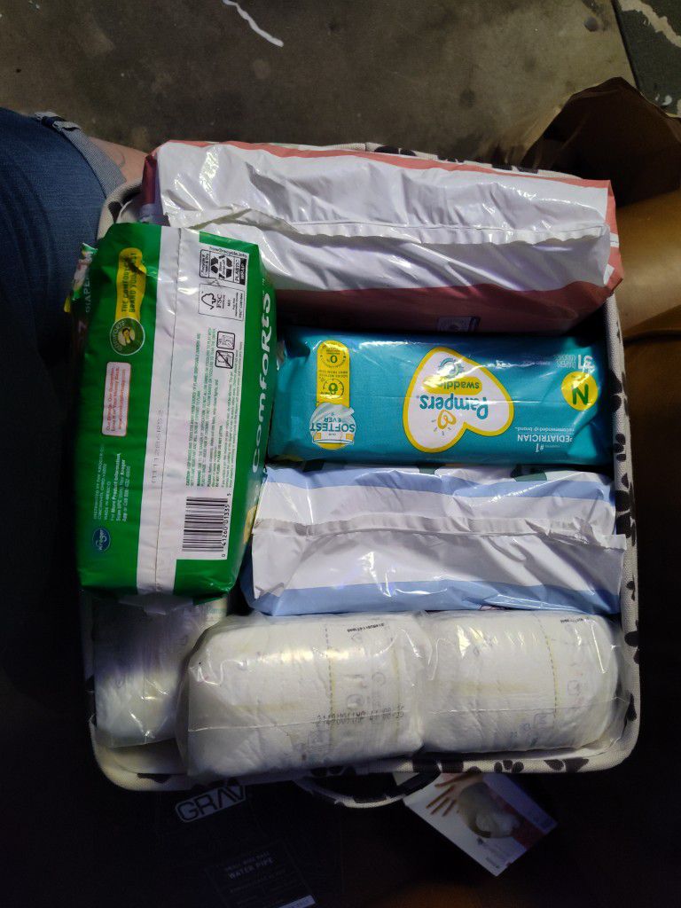 New Born Diapers And 2 Bags Of Size 2 Diapers 
