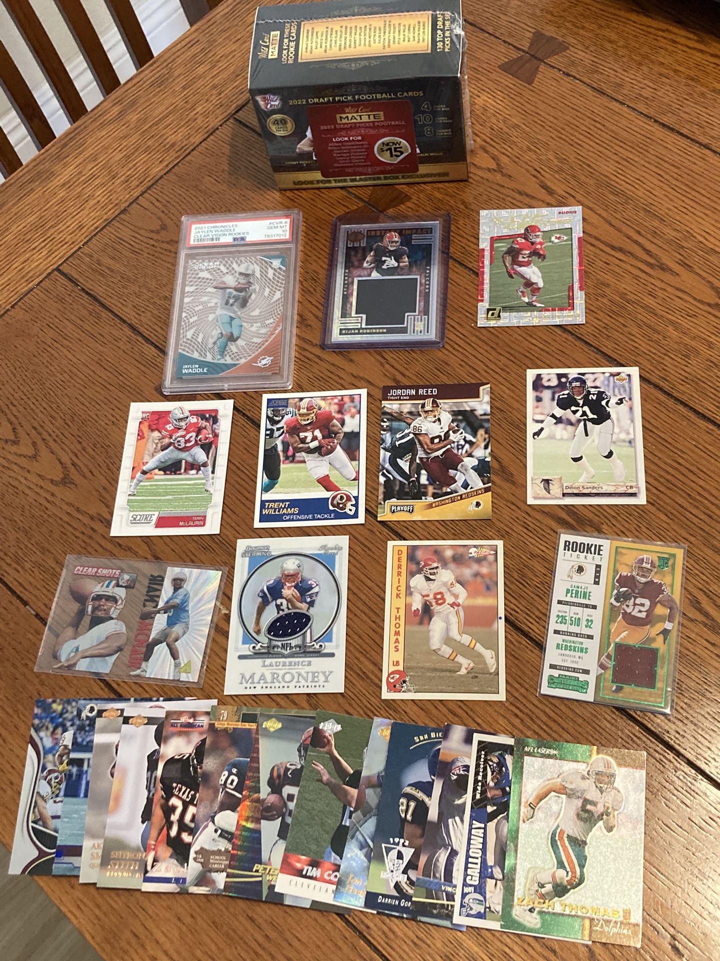 lot of NFL football cards. Including rookie cards, an unopened football box, a Jalen Waddle PSA 10 clear vision rookie, Bijan rookie jersey card