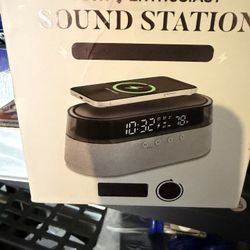 Tech Enthusiast Sound Station featuring an alarm clock, wireless charger, and Bluetooth speaker. 