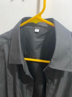 Tailored black long-sleeve button-up shirt is size S. The shirt has a classic collar, button front closure, and button cuffs.