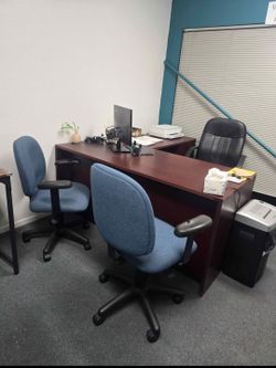 L-Shaped Mahogany Finish Office Desk with Two Blue Chairs