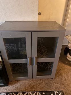 Gray Cabinet with Glass Door Panels
