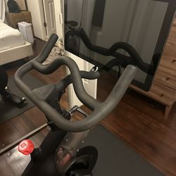Peloton bike, two three pound weights and mat