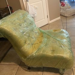 Green Lounge Chair and living Room Table With Glass Cover