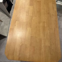 Small brown dining table with 4 suede seated chairs