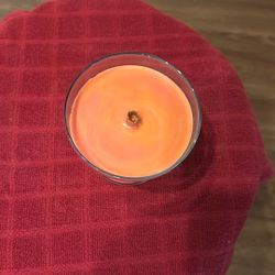 Peach Colored Wood Wick Candle In Glass With An April Fresh Scent