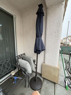 Outdoor patio umbrellas, including solar-powered LED